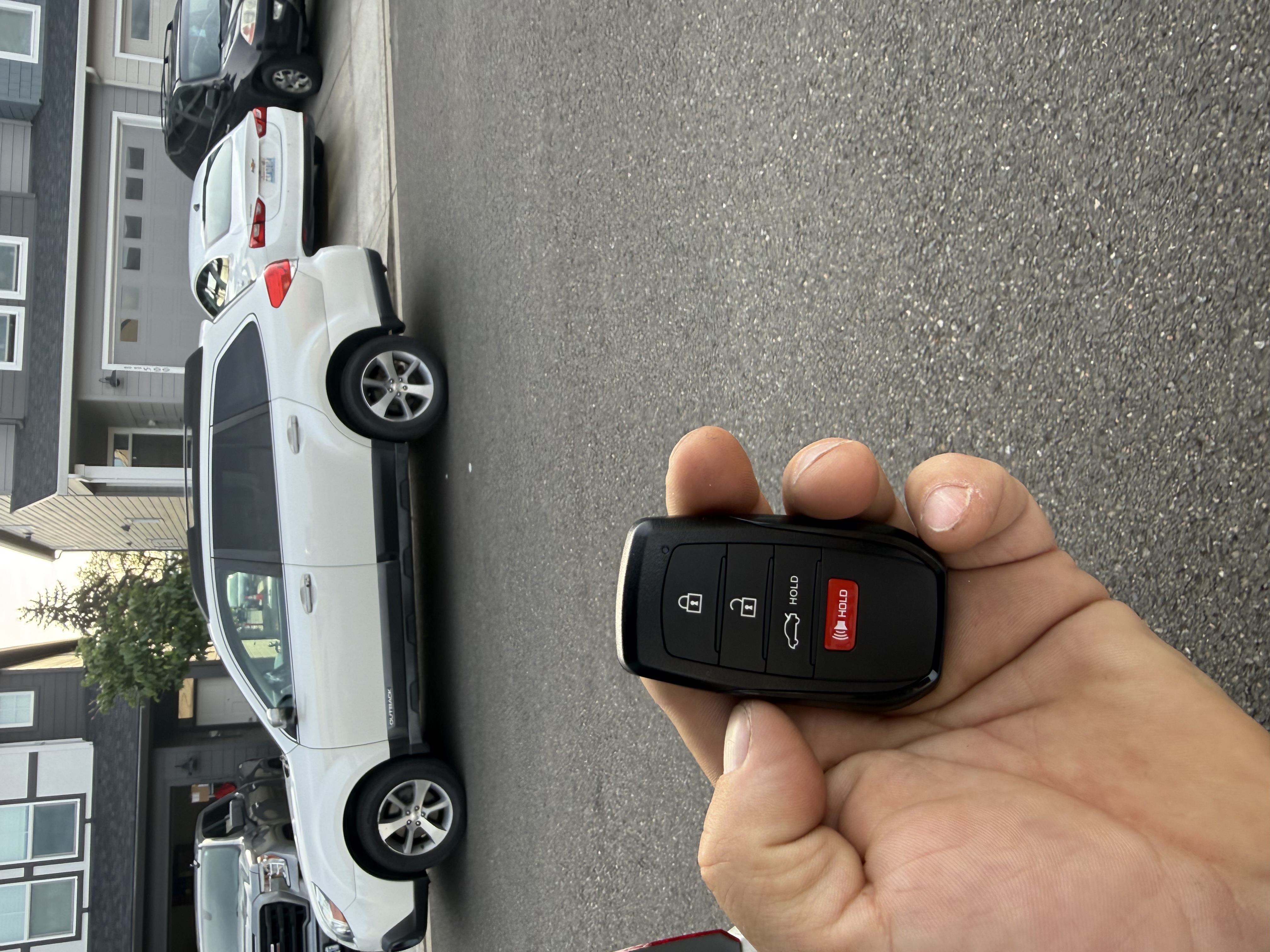Car key replacement — locksmith holding new smart key fob