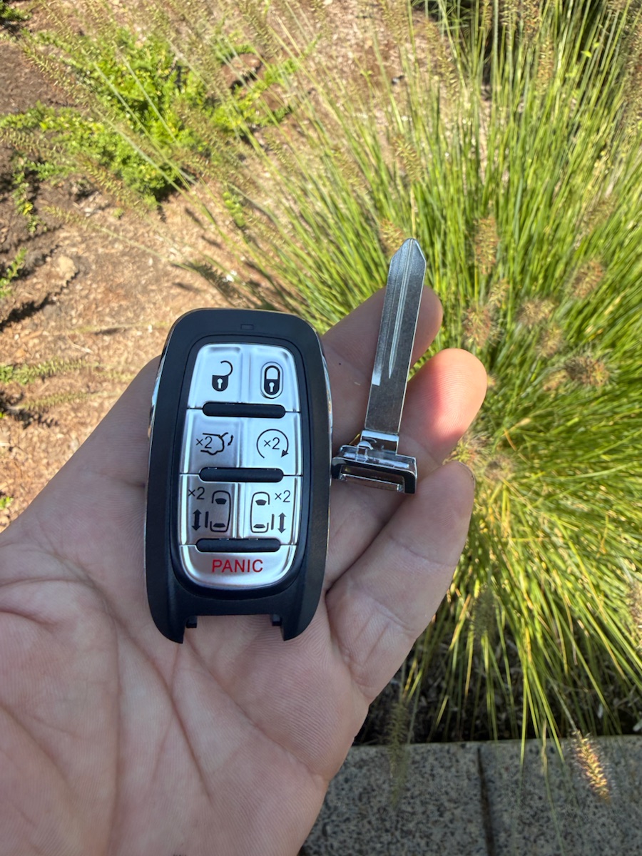 Chrysler Pacifica 7-button smart key with emergency blade — one of the keys we carry.